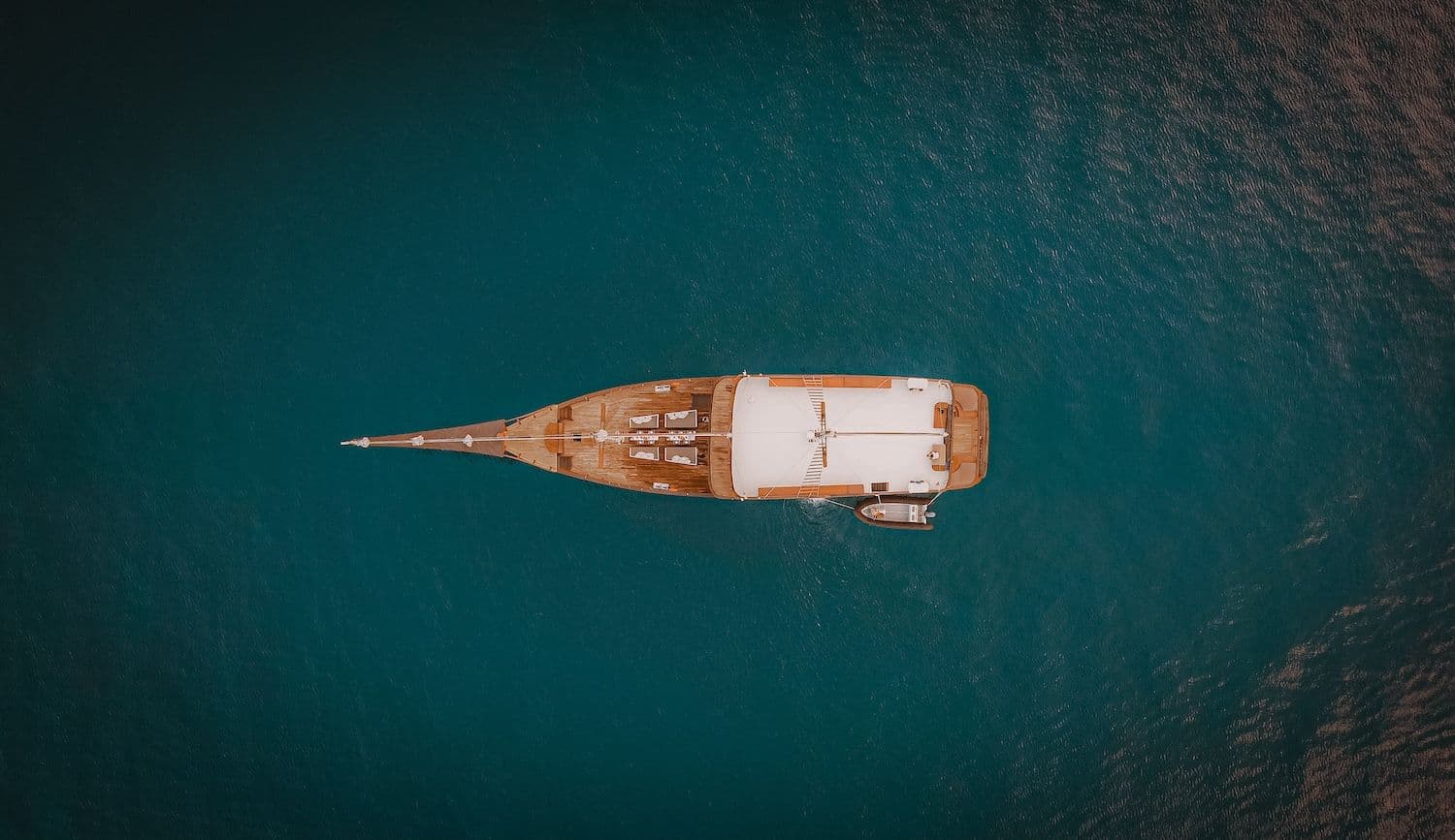 samsara boat, wooden boat exterior, turquoise sea water