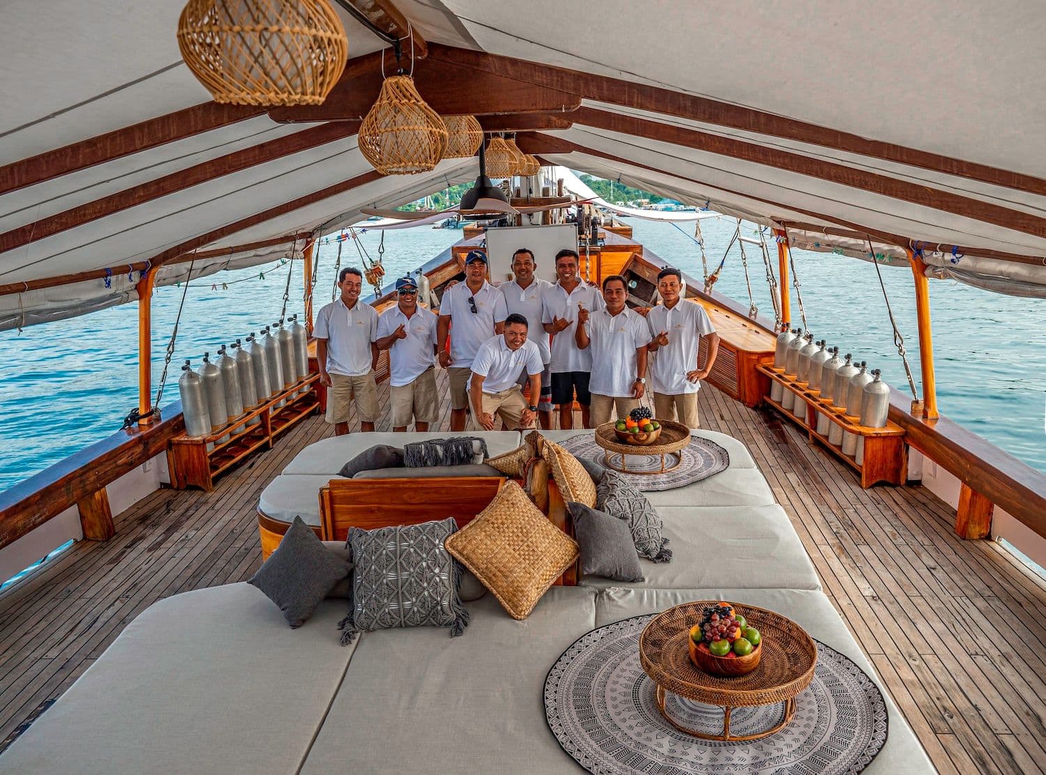 anne bonny crew on the deck, big sofa with many pillows, rattan lamp