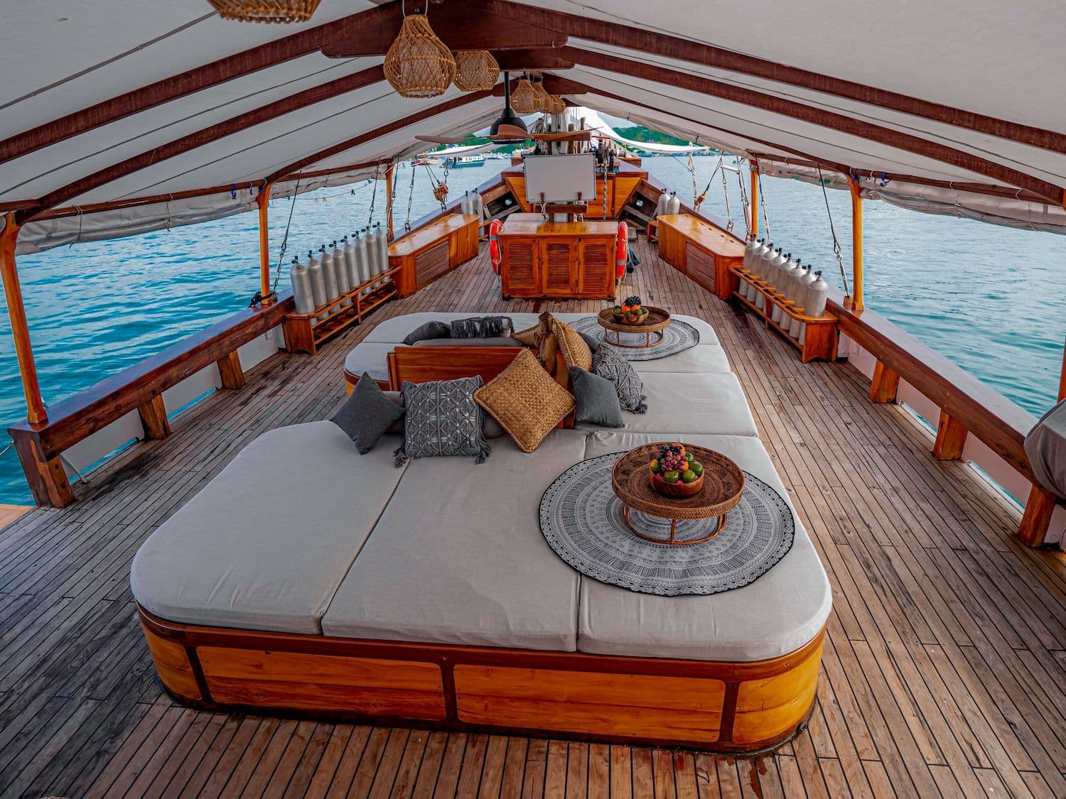 anne bonny deck, big sofa with many pillows, rattan lamp, white ceiling