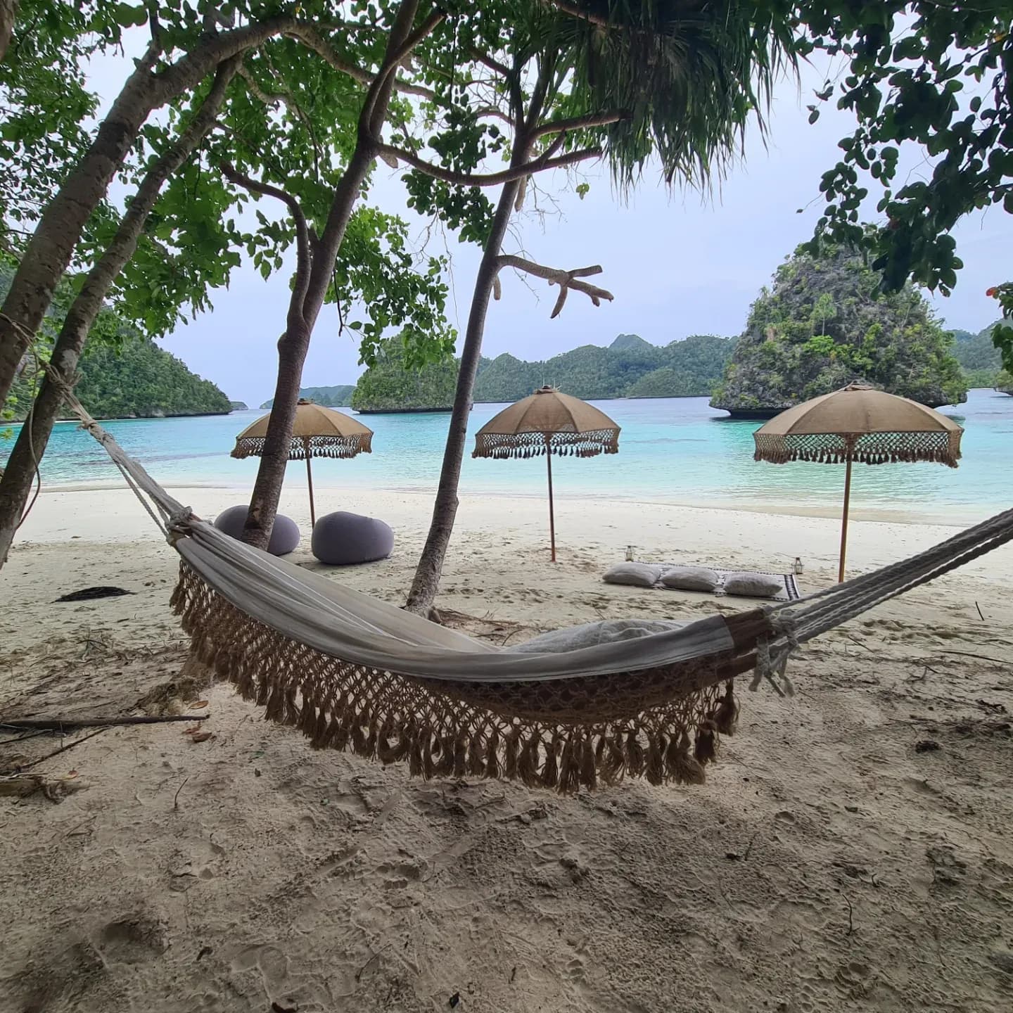 beach set up anne bonny, swings on the tree, white umbrellas, beautiful beach view