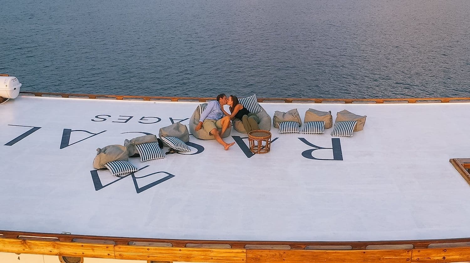 couple kissing on rooftop at rascal with beautiful view