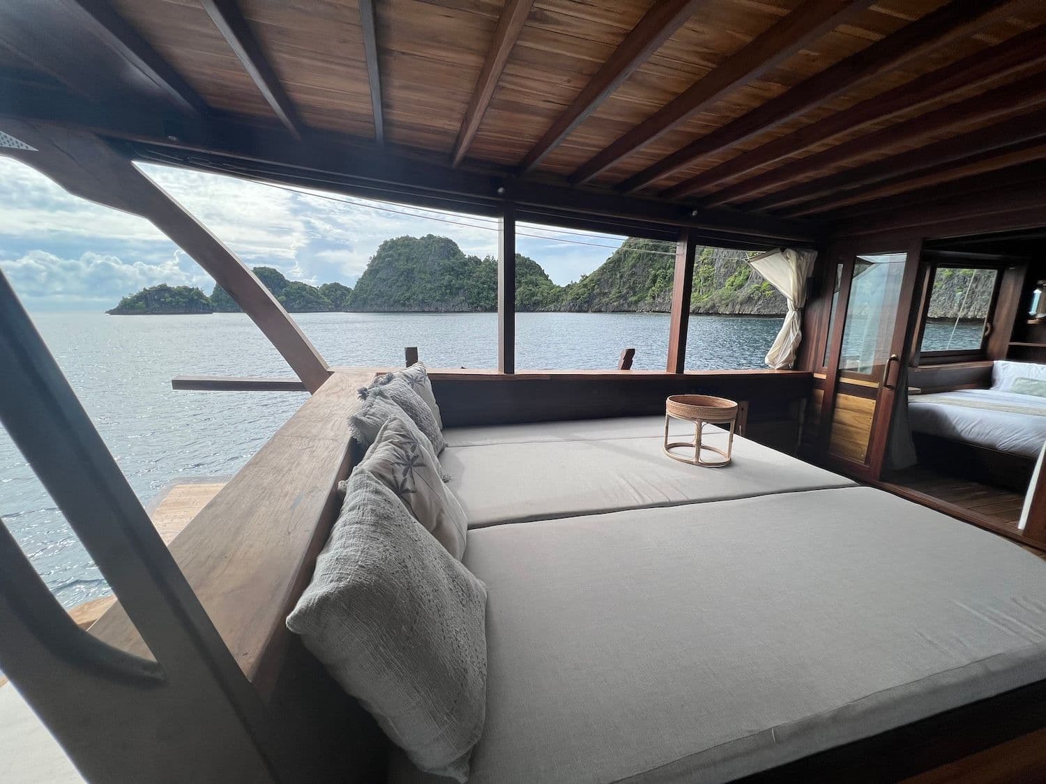 chill deck, wooden interior, island view, sea water, bright sky