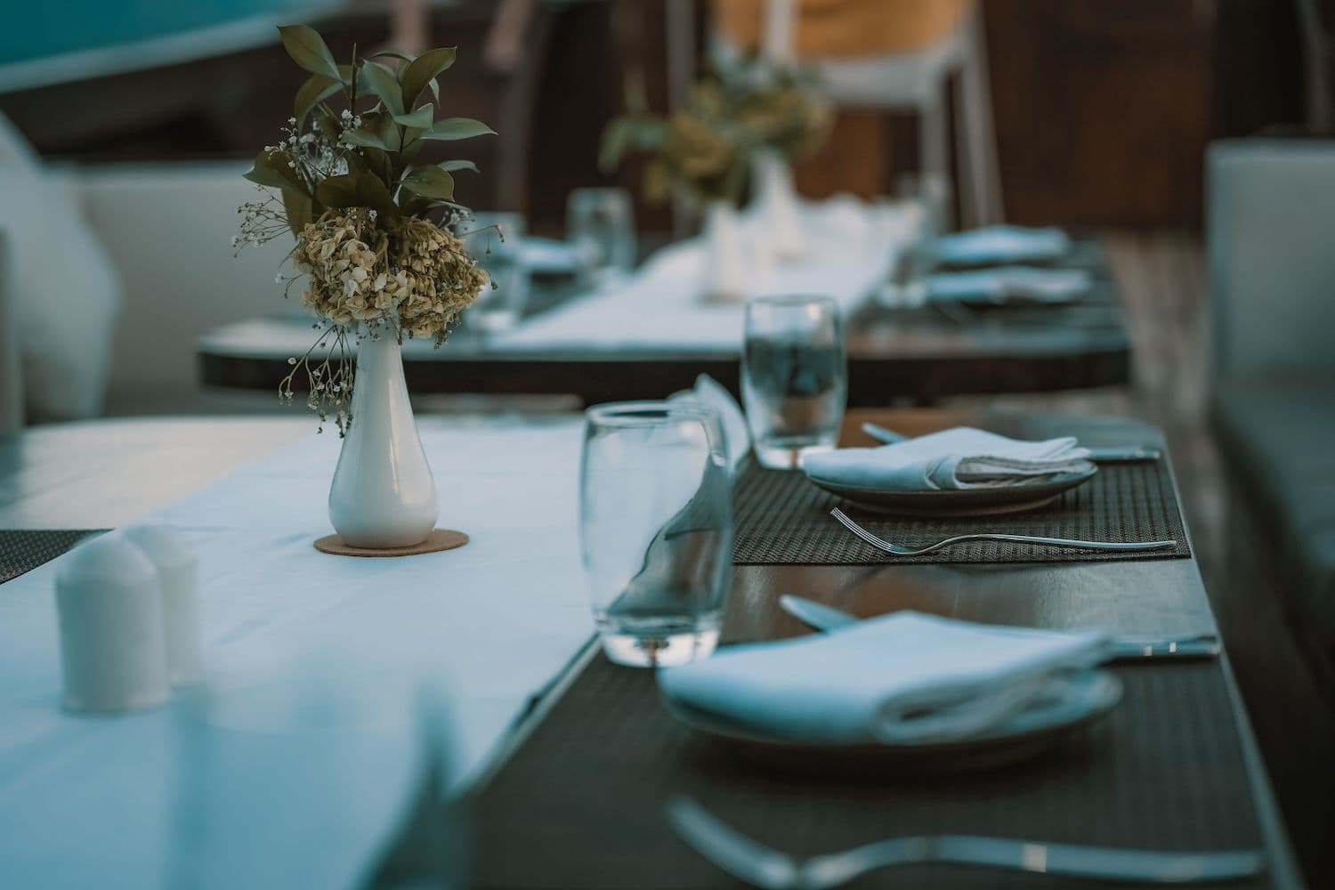 table setting at the samsara samudra boat, white table mat, flower vase on the table, cutleries, 