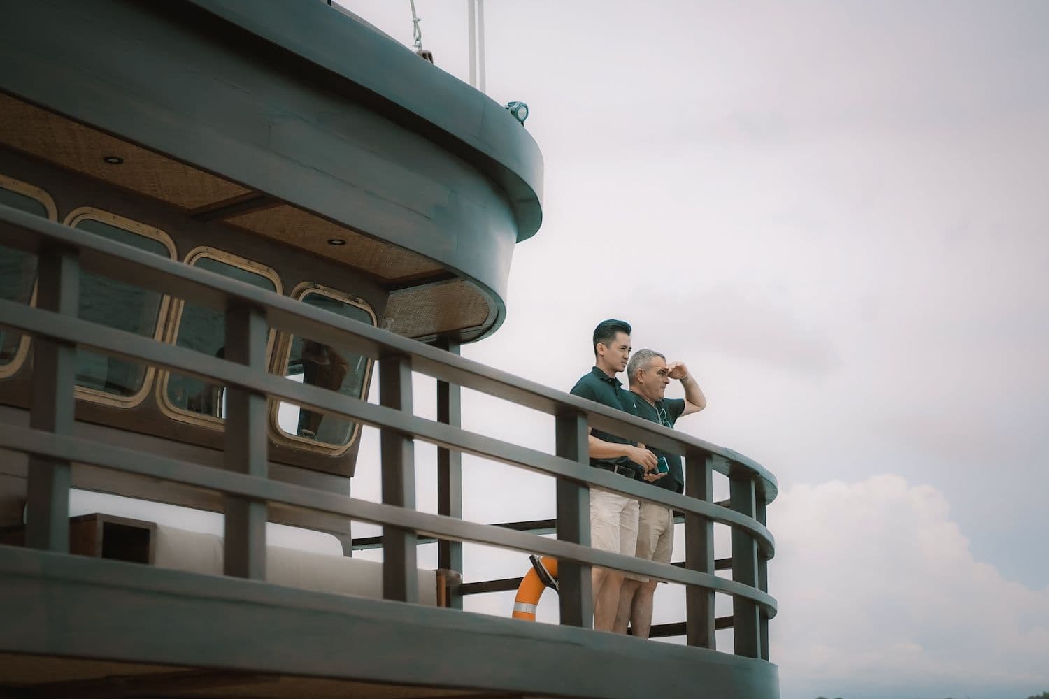 two man standing on the deck, wooden exterior