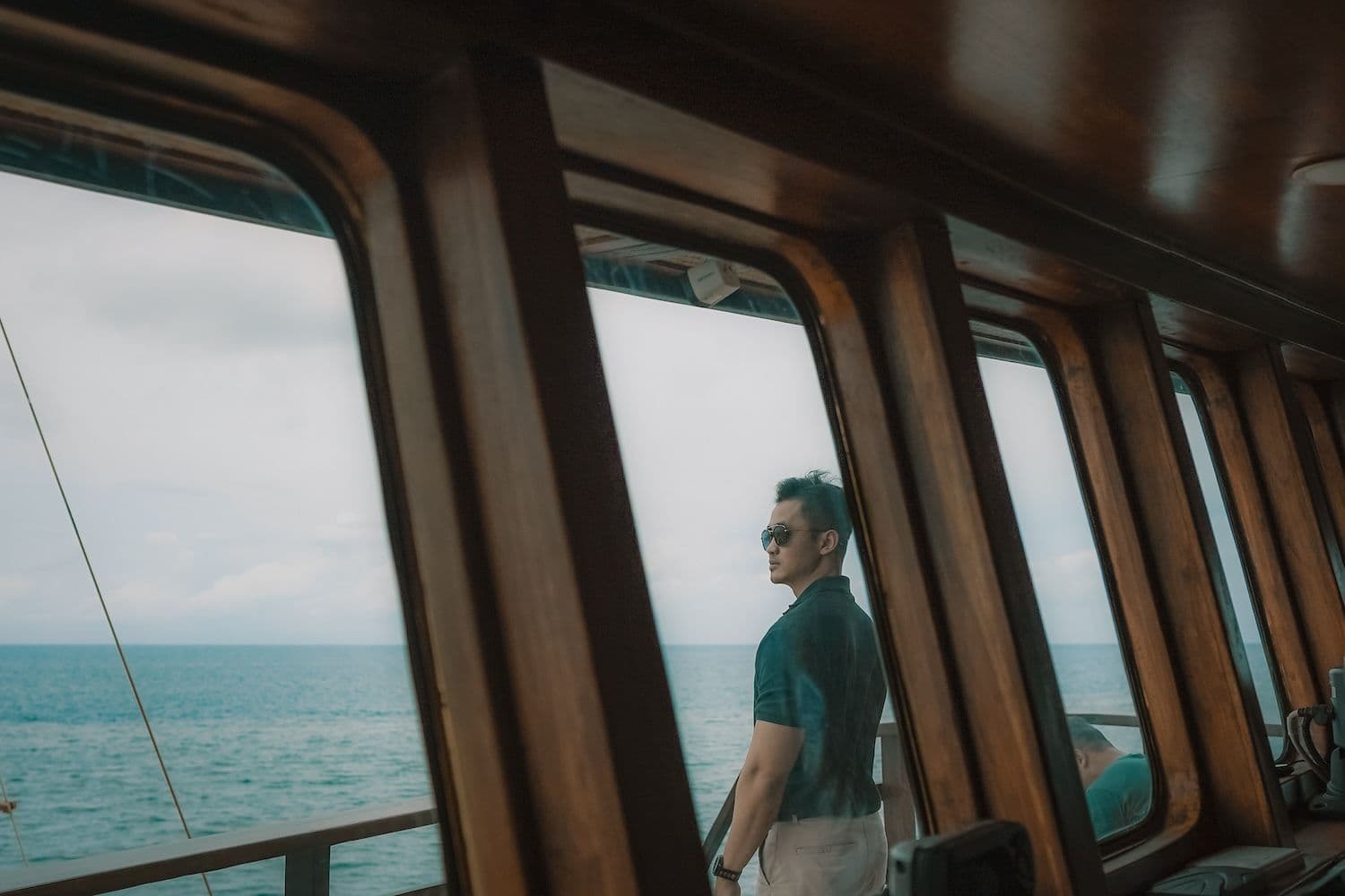 a man standing on the main deck, wooden interior