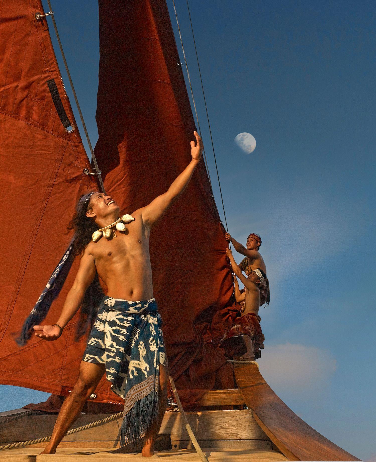 si datu bua boat with grand red sail, two people on the si datu bua boat, blue sky, sea view