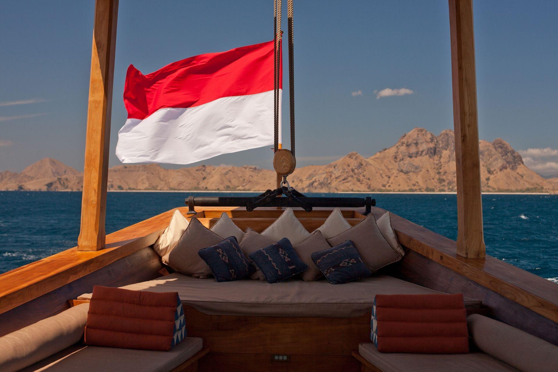 si datu bua boat with beautiful sea view, indonesian flag, beautiful sky, relaxing place with many pillows