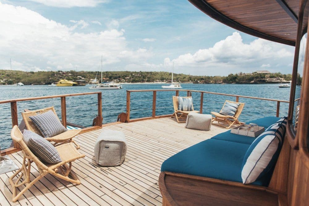 rascal boat on the main deck, blue sea water, blue sky, relaxing bench