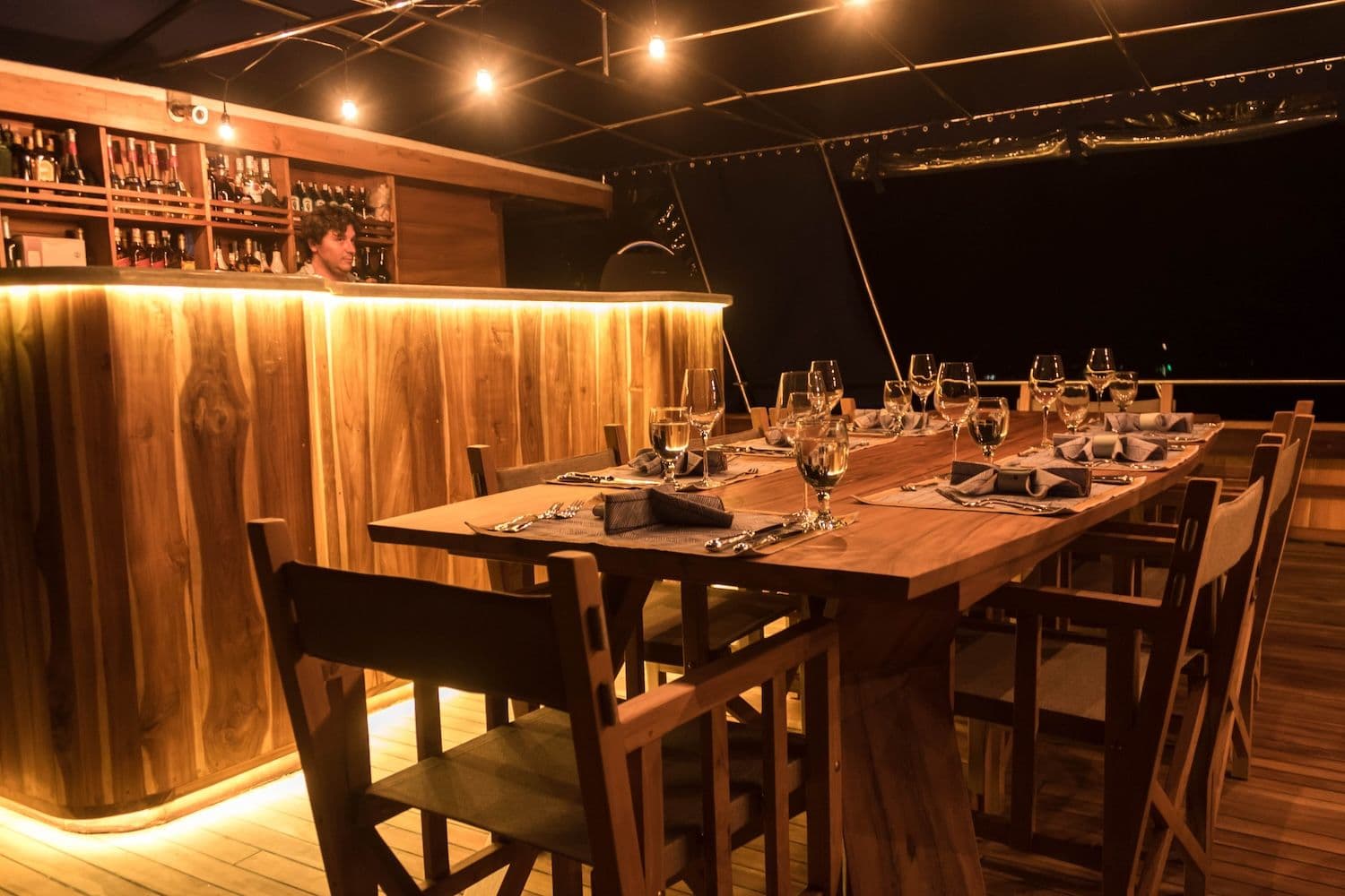 wooden dining table, yellow lights, bar table