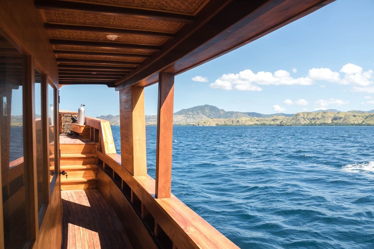 blue sea water, hill view, wooden exterior, deck view