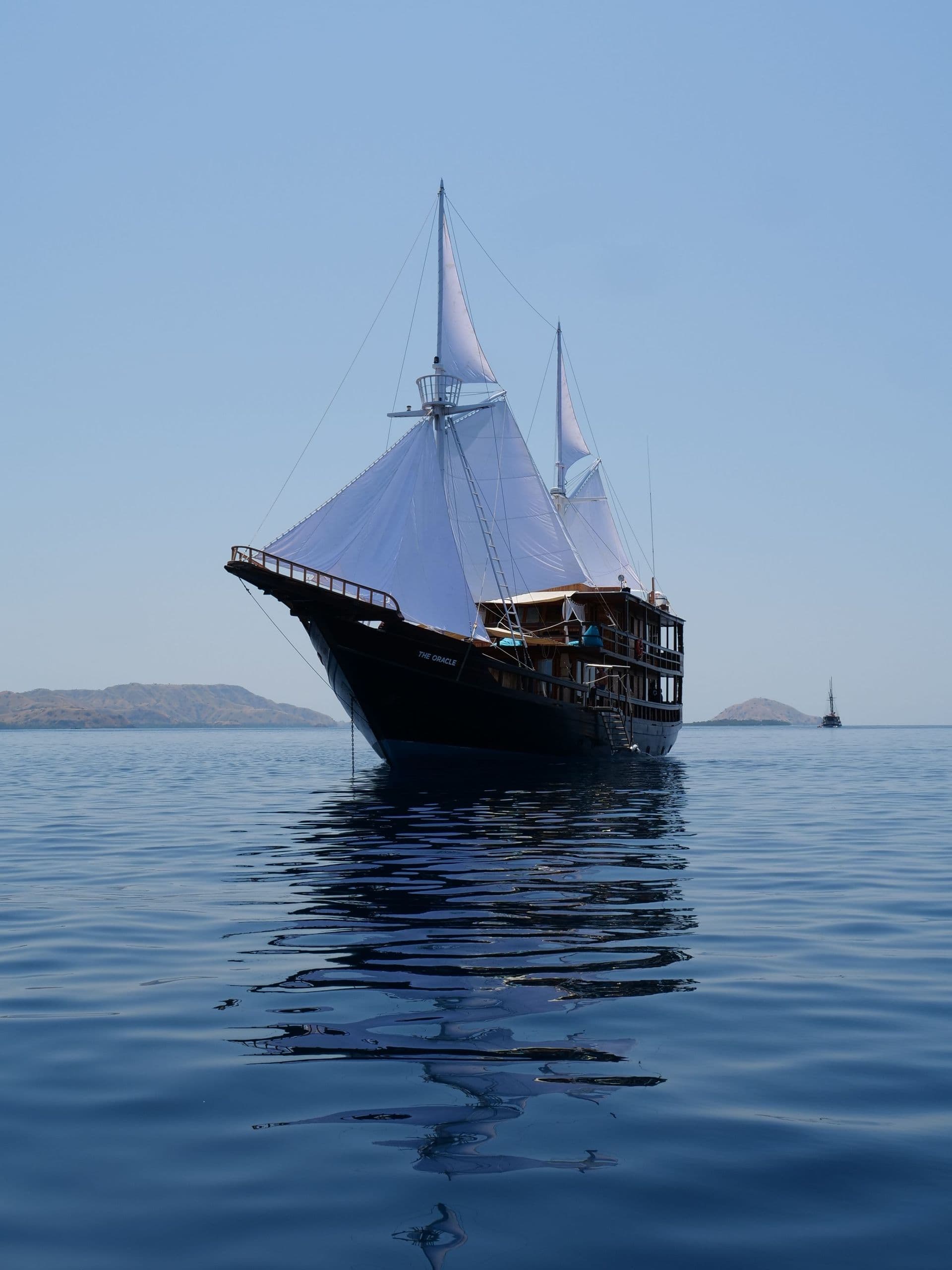 oracle boat portrait, white sail, blue view