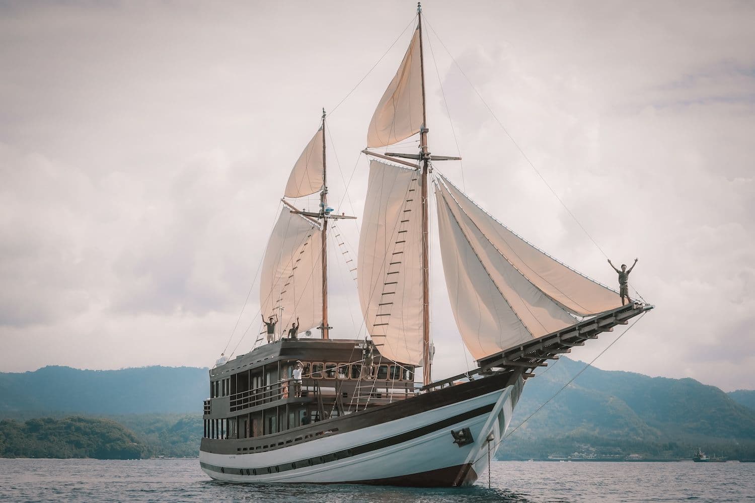 samsara samudra boat, white big sail, couldy atmoshphere